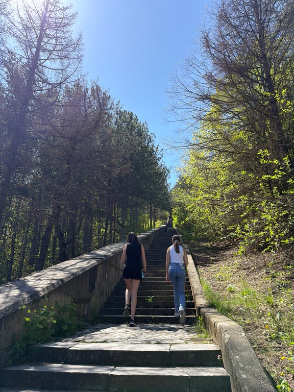 Two women walk outdoor staircase in Shumen, Bulgaria