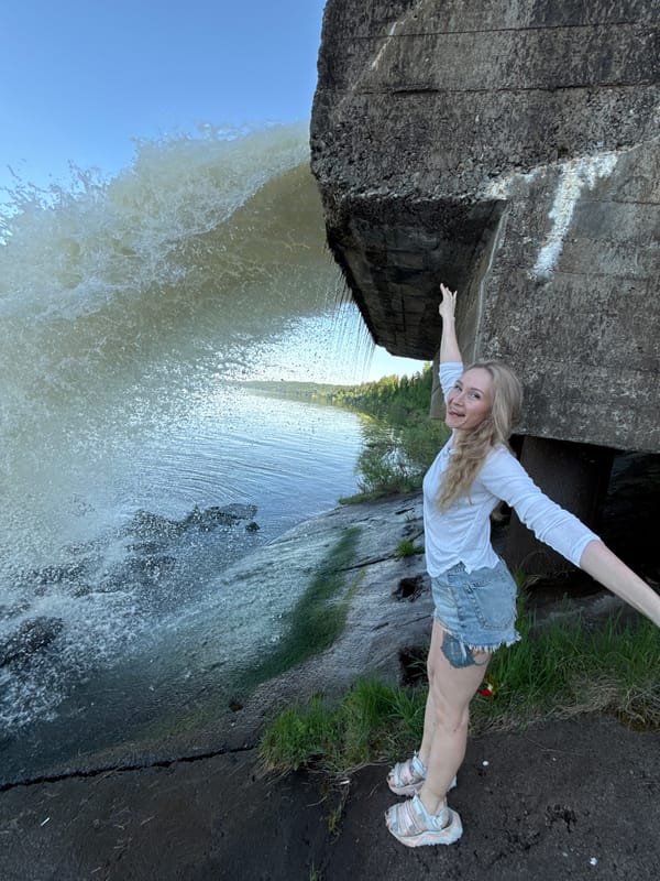 Woman and boy visit waterfall concrete structure in Noviy