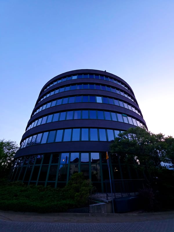 Warsaw business district at dusk, office towers and quiet streets