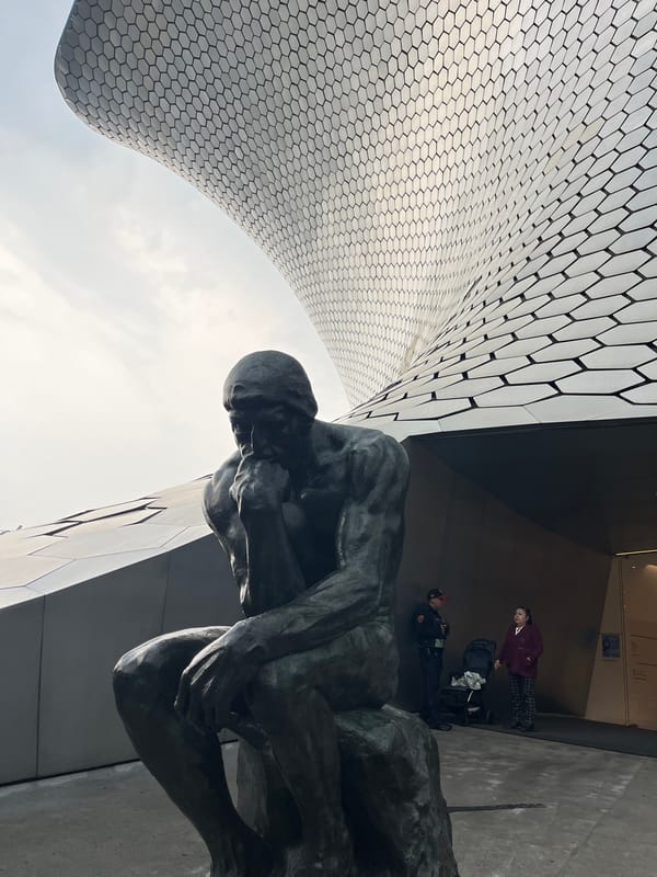 Museo Soumaya's metallic exterior and Rodin's Thinker, Mexico City