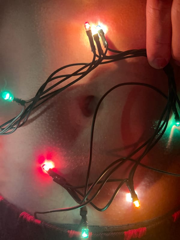 Person decorates body with colorful Christmas lights in Russia