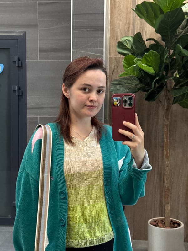 Mirror selfie showcasing a layered knit outfit in Izhevsk