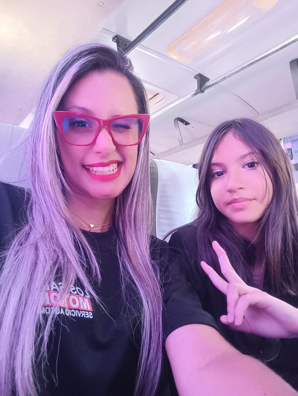 Adult and child take playful selfies in Las Tejerías