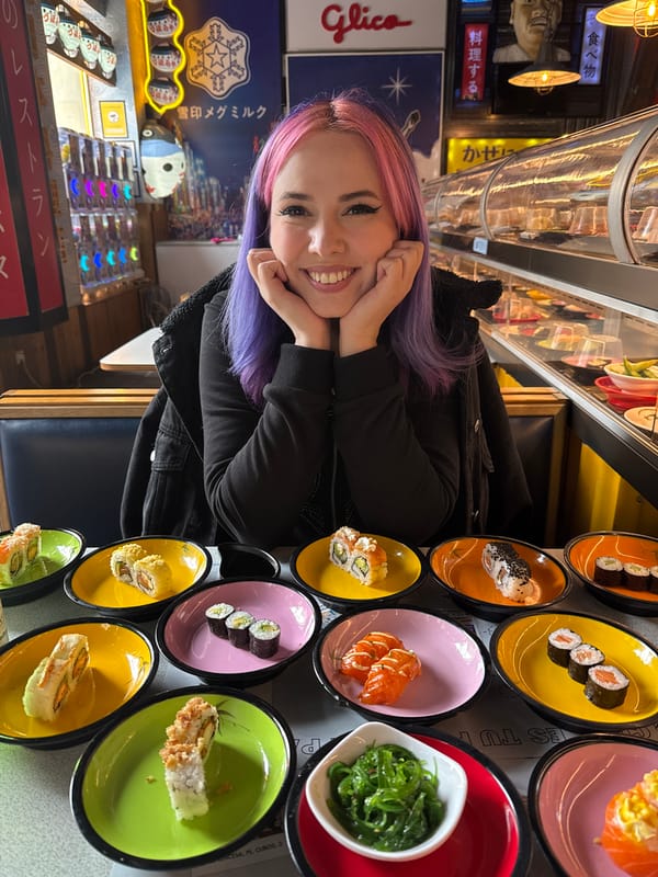 Woman with colorful hair enjoys sushi dining in Madrid