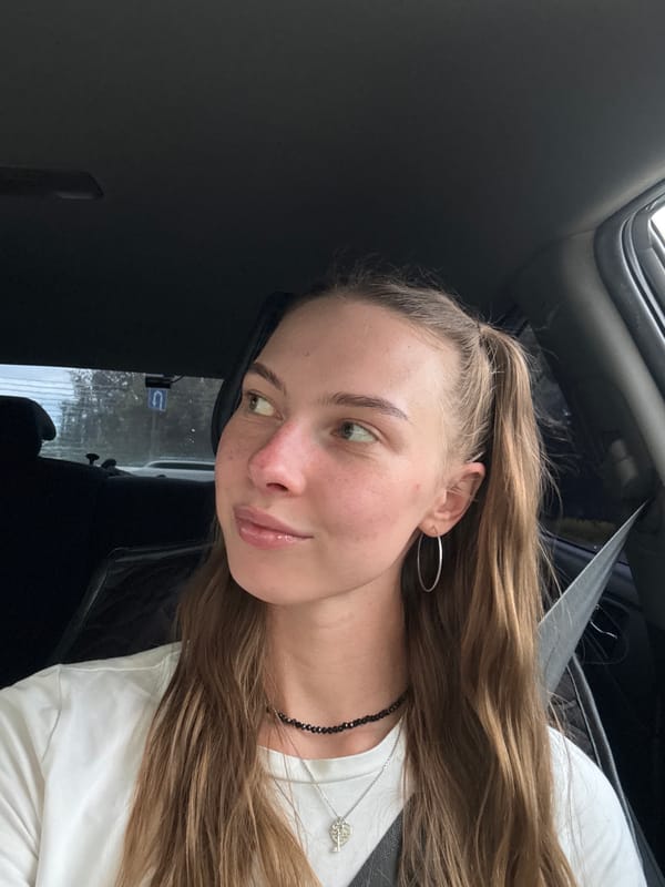 Woman takes selfies in car during afternoon in Perm
