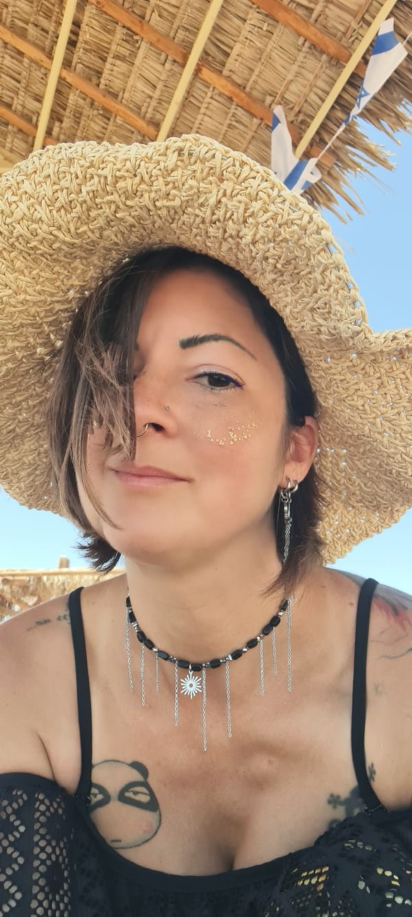 Woman relaxes under beach umbrella in sunny Eilat morning