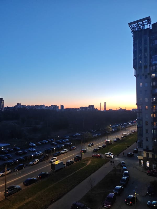 Evening smoking break overlooking Saint Petersburg cityscape at dusk