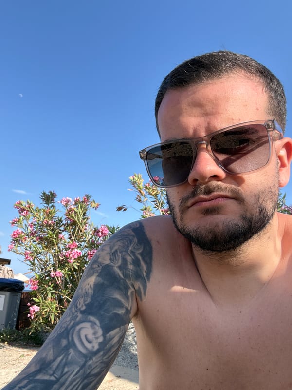 Tourist takes selfie among pink flowers in Kos, Greece