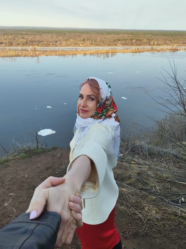 Woman in traditional dress observed on Kama riverbank in Sarapul
