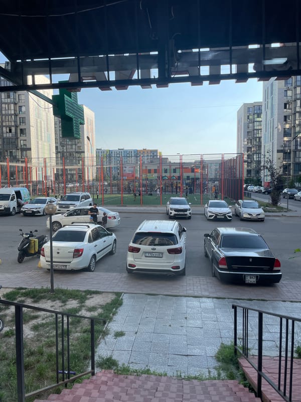 Afternoon stroll through a modern Almaty residential complex