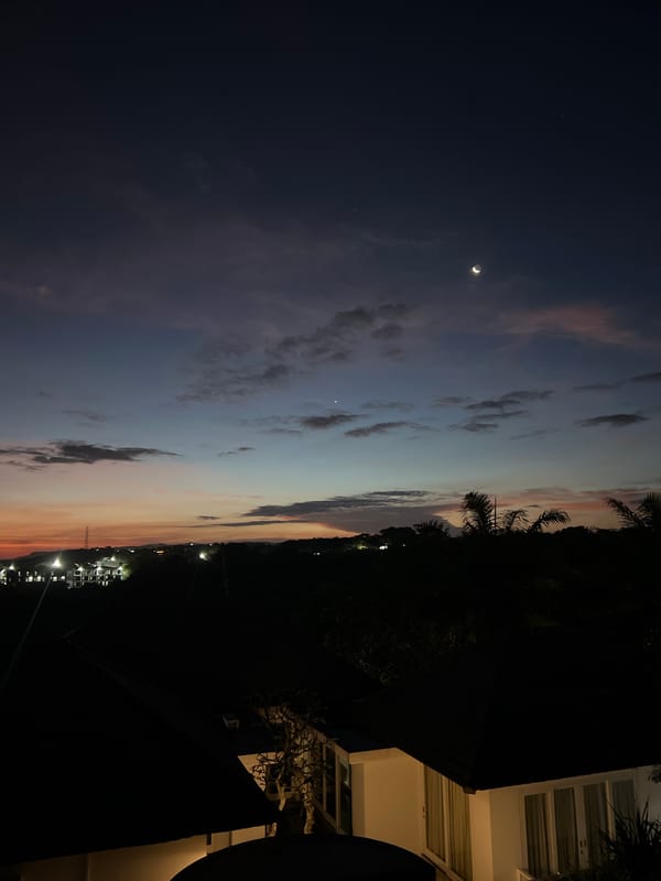 Crescent moon twilight scene witnessed from urban balcony