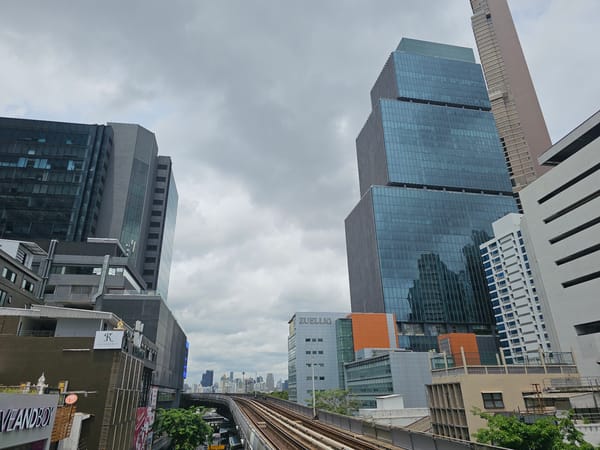 BTS platforms, mall eats, and Bangkok streets on a grey morning