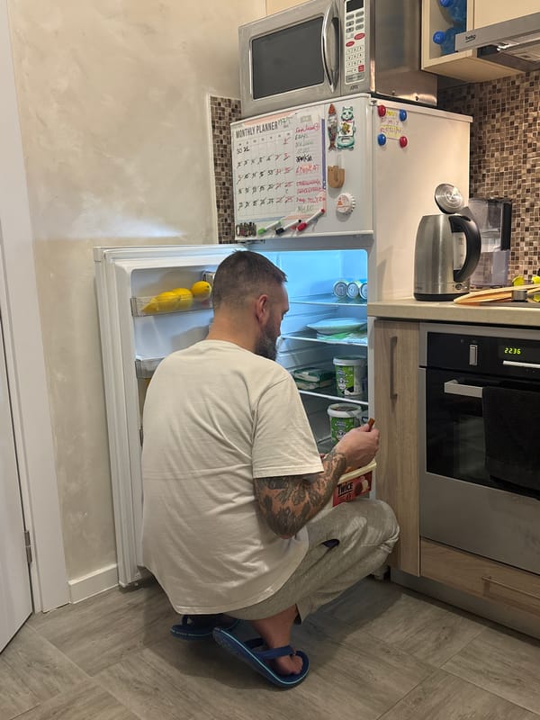 Person accessing refrigerator in Montenegro kitchen
