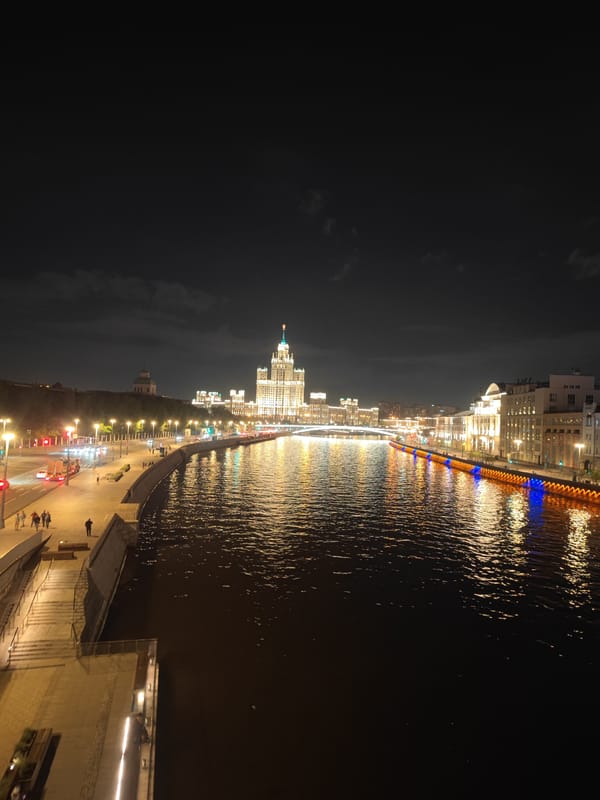 Nighttime view captures Moscow's iconic Stalinist skyscraper along Moskva River