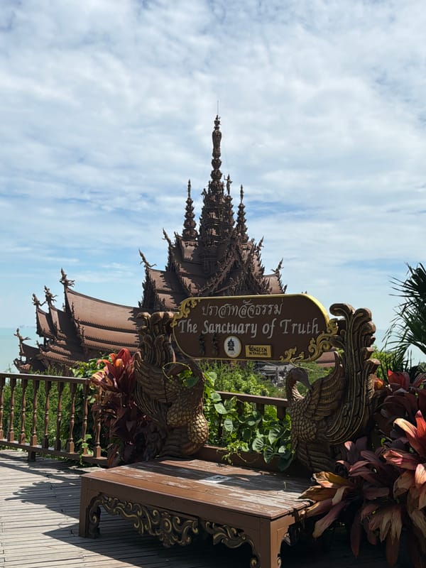 Tourist visits ornate wooden Sanctuary of Truth temple in Pattaya
