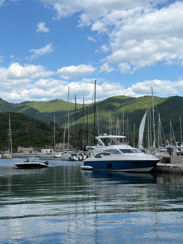 Sailboats docked at Montenegro marinas under afternoon skies