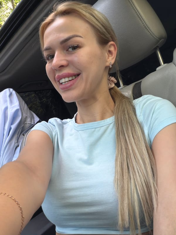 Car selfie session in Kyiv, sunroof open, glass tower nearby