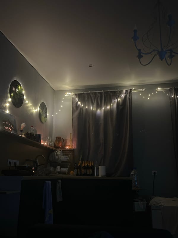 Interior space in Liepaja features blue chandelier, string lighting