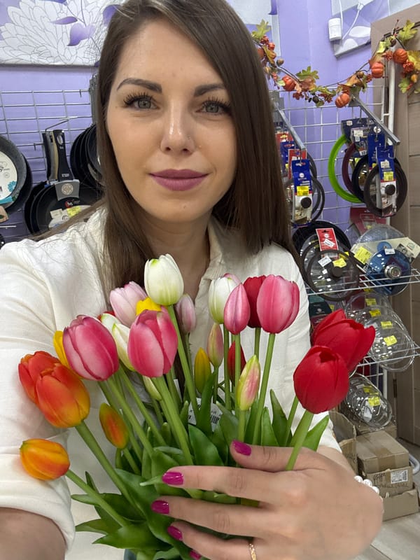 Woman documents flower shopping experience in Klin retail center