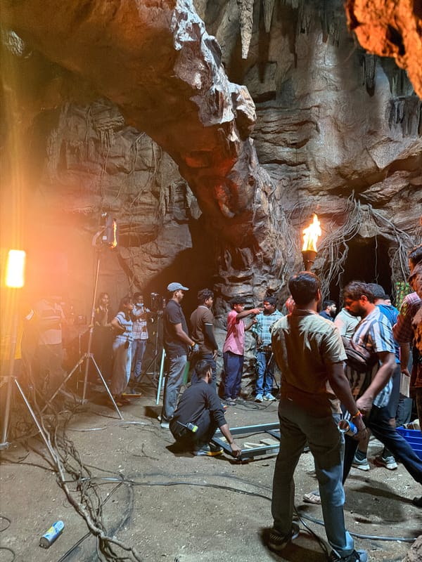 Film crew works inside a dramatic cave set in Hyderabad