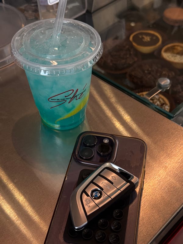 Branded blue drink photographed with phone, BMW key in Yerevan