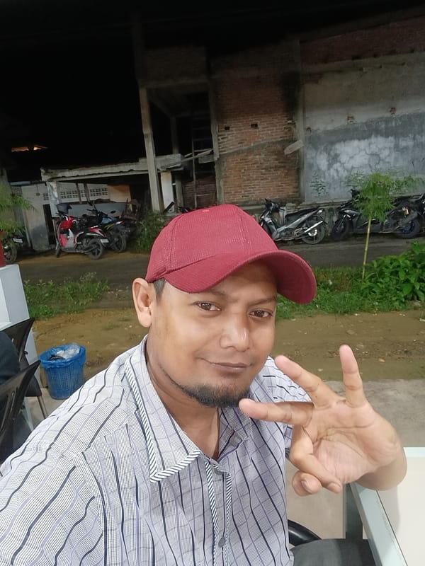 Men photographed making hand gestures in Lhokseumawe, Indonesia
