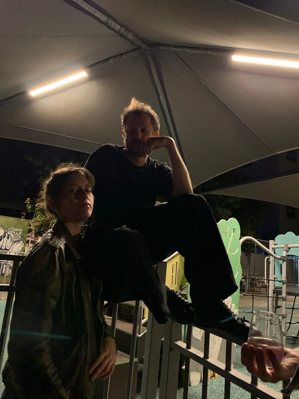 Nighttime gathering of three people in Tel Aviv outdoor area