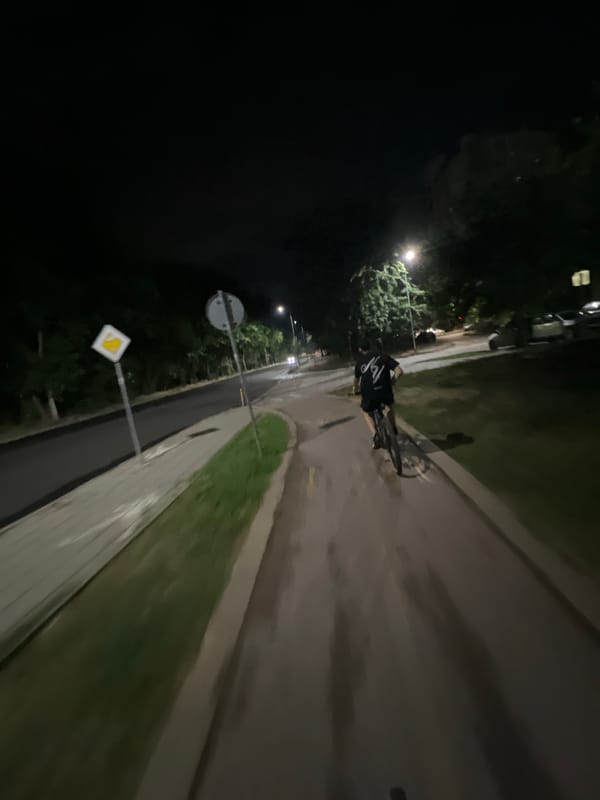 Nighttime cycling through Plovdiv's lit park paths and streets