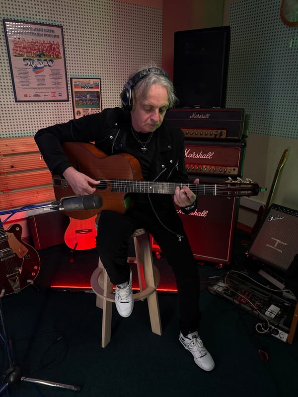 Musician records acoustic guitar session in Moscow studio