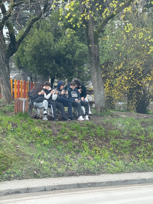 Young people gather on park bench in Veliko Tarnovo