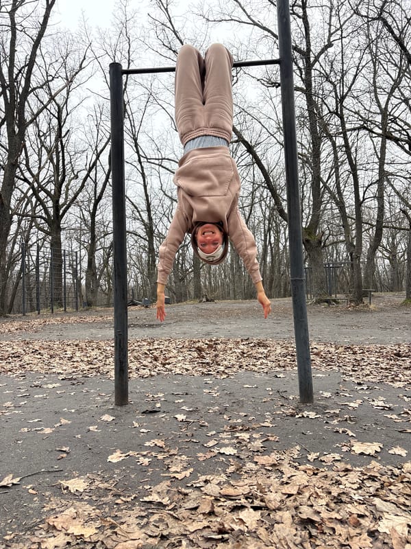 Woman performs inverted calisthenics at Ulyanovsk park outdoor gym