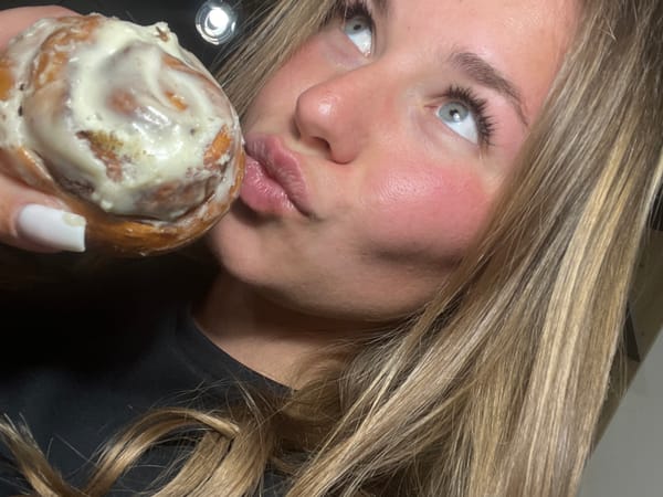 Woman enjoys glazed pastries in Budva selfie session