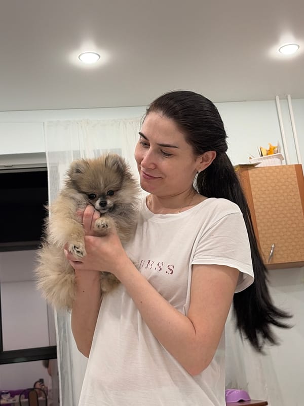 Woman cooks dinner with pet dog in Sertolovo home