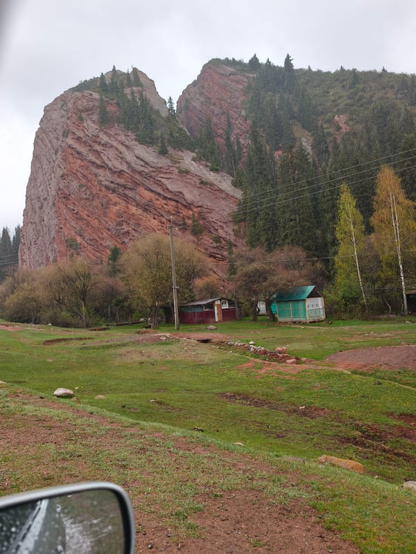 Traveler documents Kyrgyzstan's red rock formations during morning rain