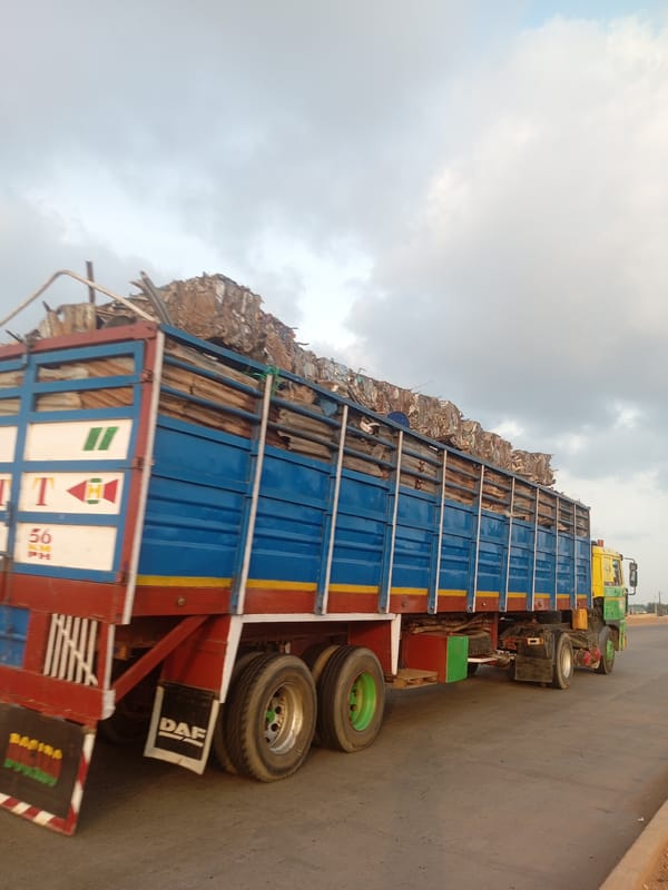Trucks, traffic, and construction along a busy Nigerian road corridor