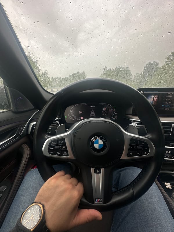 BMW driver navigates rainy roads at high speed