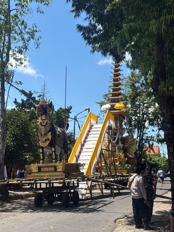 Religious procession with ceremonial floats observed in Pejeng, Indonesia