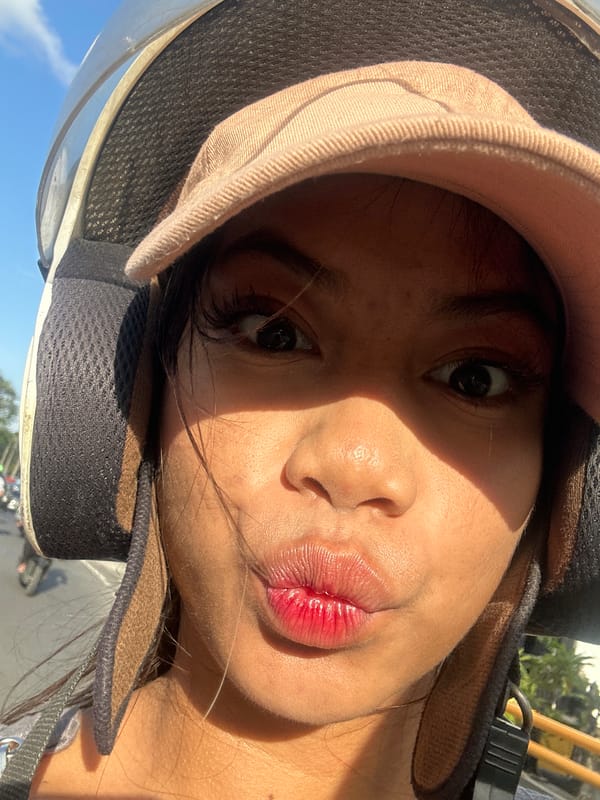 Helmet selfies on a Denpasar street mid-morning ride