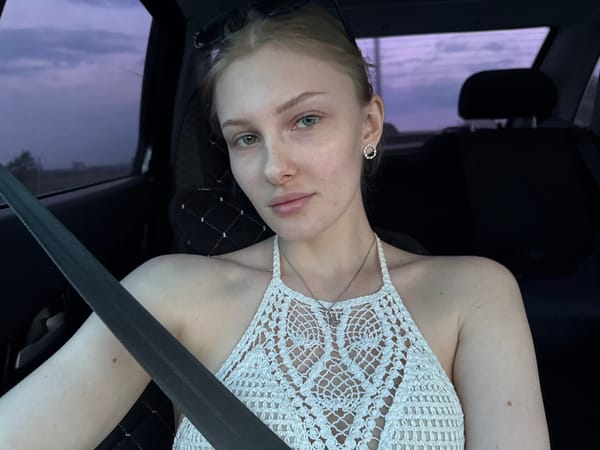 Woman in white crochet top documented in vehicle near Kondratovo