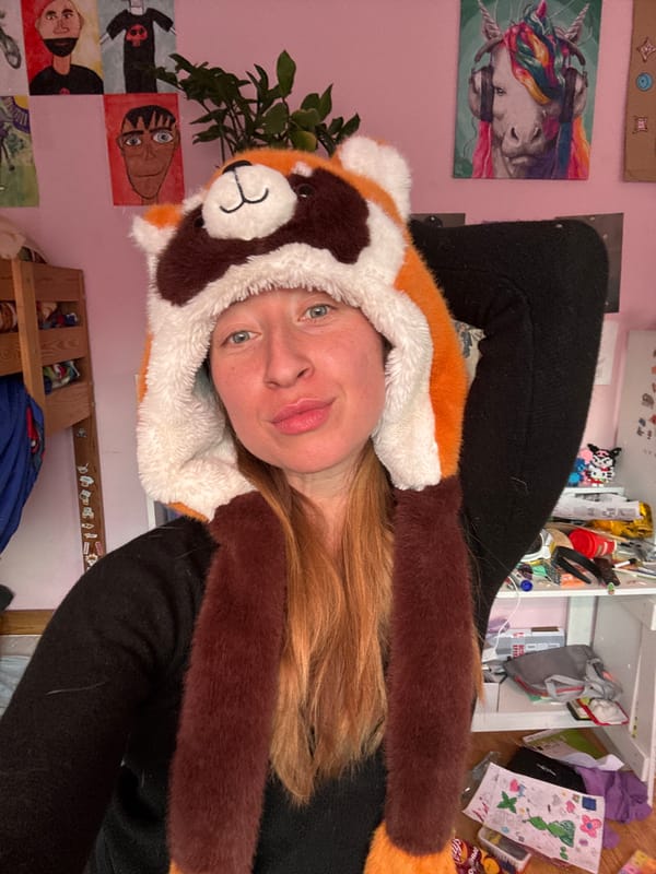 Woman in red panda hat photographed with tulips, Noviy
