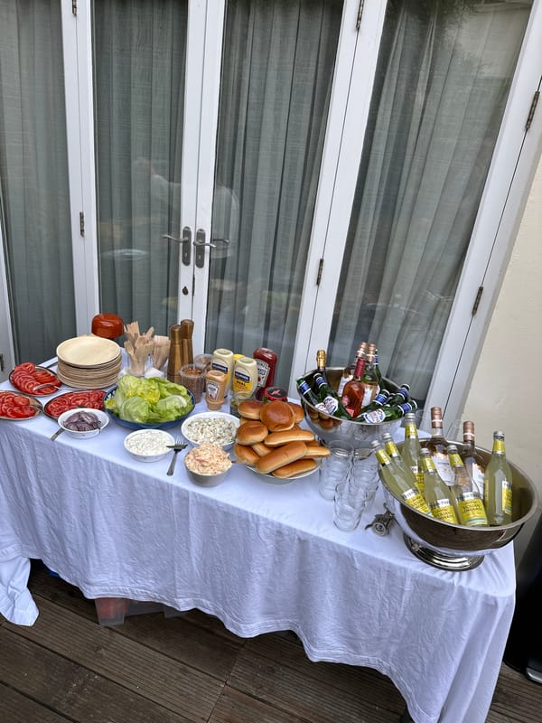 Small outdoor gathering with buffet and dog in London