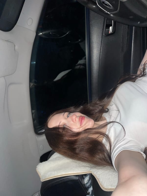 Woman photographed in car interior during evening in Gavrilovka