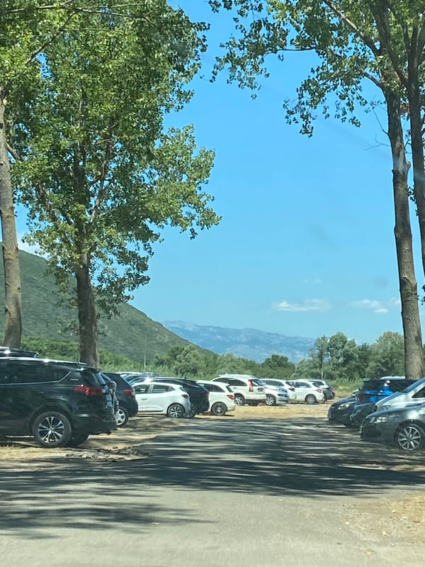 Summer gathering at a Montenegro campsite, mountains in the backdrop