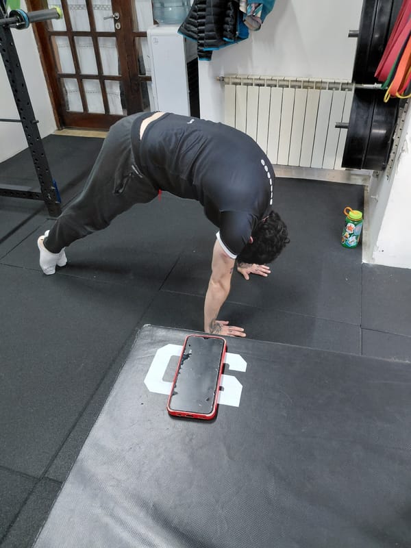 Man stretches against wall during gym workout in Ushuaia