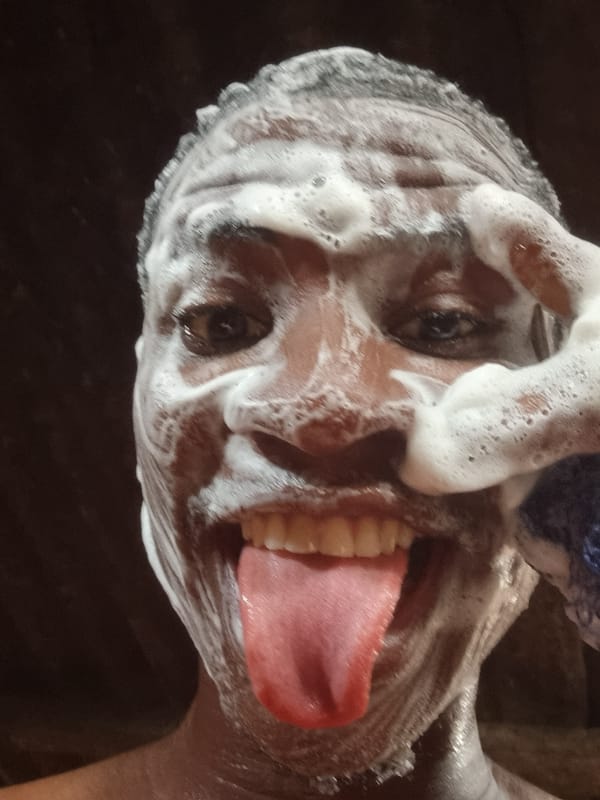 Man bathes outdoors in Onitsha, Nigeria