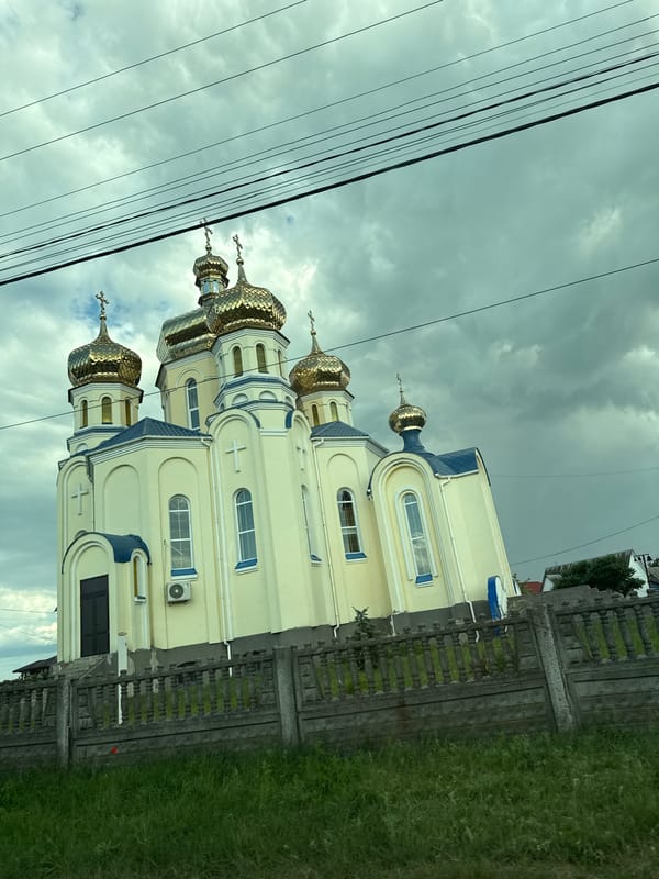Golden-domed Orthodox church with blue trim in rural Ukraine