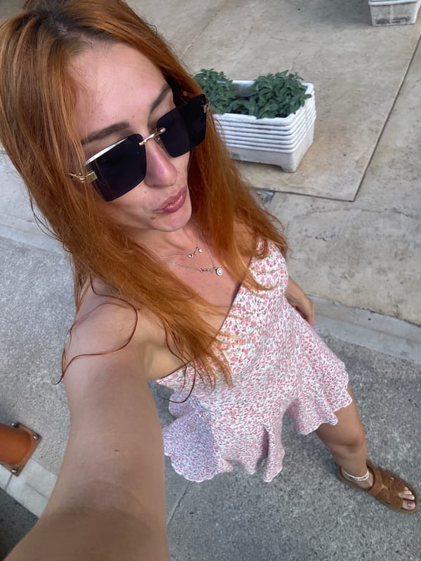 Woman takes selfies while strolling through Budva, Montenegro