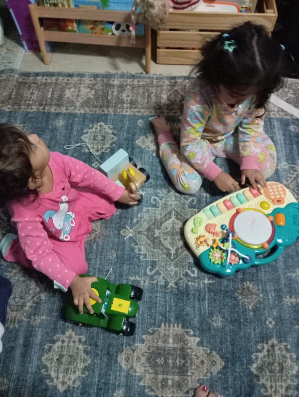 Children's playtime documented in Dubai home during evening hours