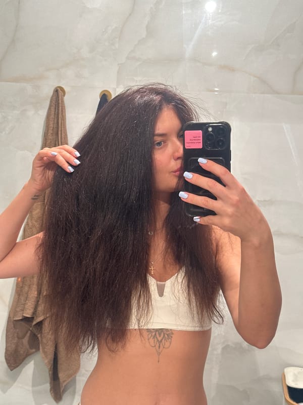 Woman takes mirror selfie in Moscow indoor setting