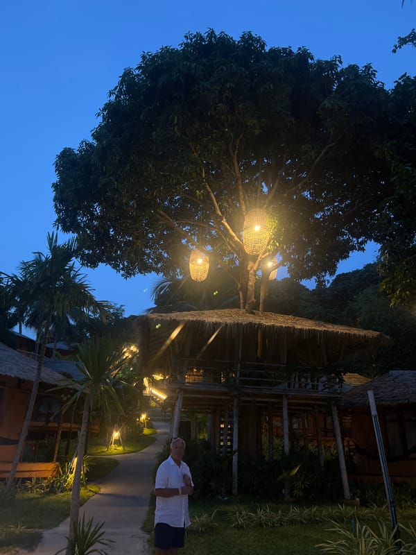 Evening lantern displays illuminate tropical beach in Thai village
